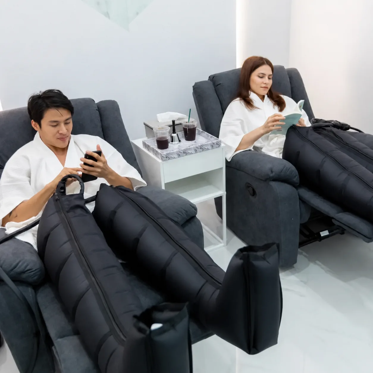 Two guests using compression boots during a recovery session